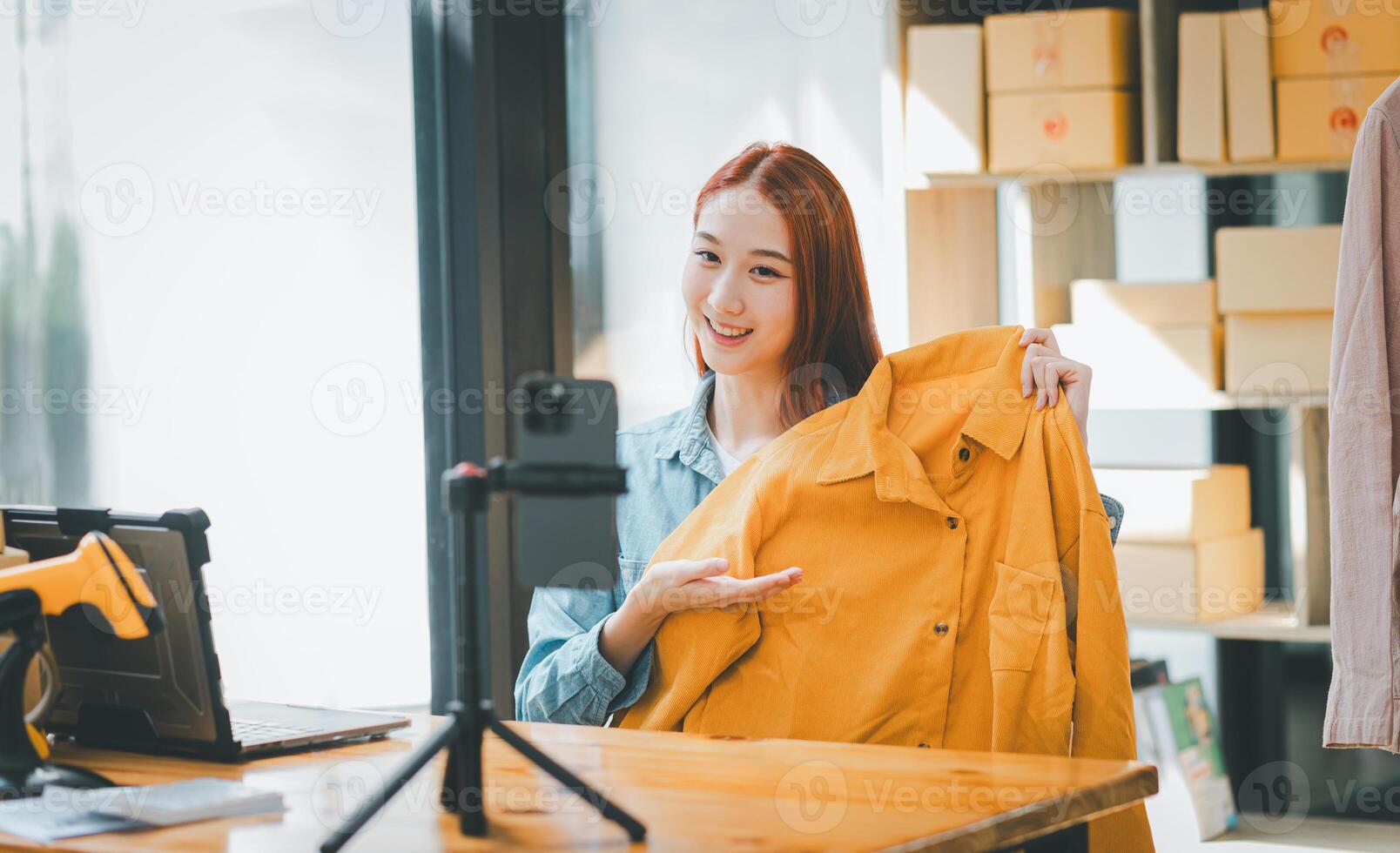 SME owner using the smartphone and tablet for recording . vlog and live stream at her shop,SME business concept, online shopping. photo