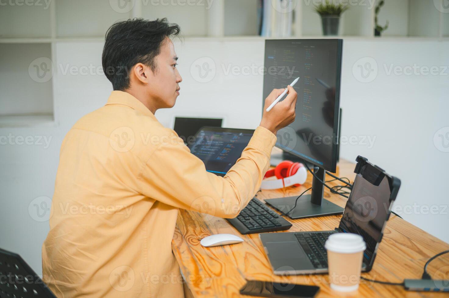 Young programmer working on coding, software development and web design in software company office.Concept technology development photo