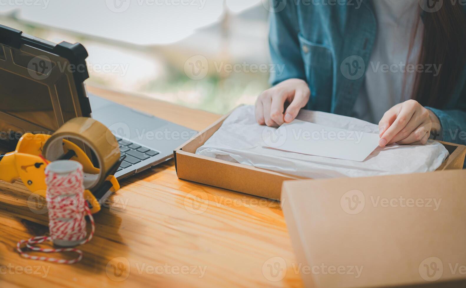Closeup small business owners online Prepare to package products for delivery to customers according to their orders with a blank white label or business card to write a message. photo