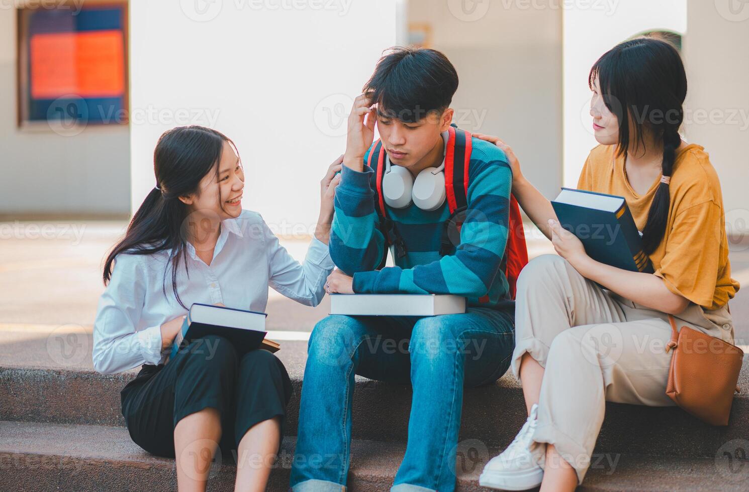 Fellow students are consoling friends who are disappointed in grades, frustrated with tasks that are not meeting their goals, helping each other. photo