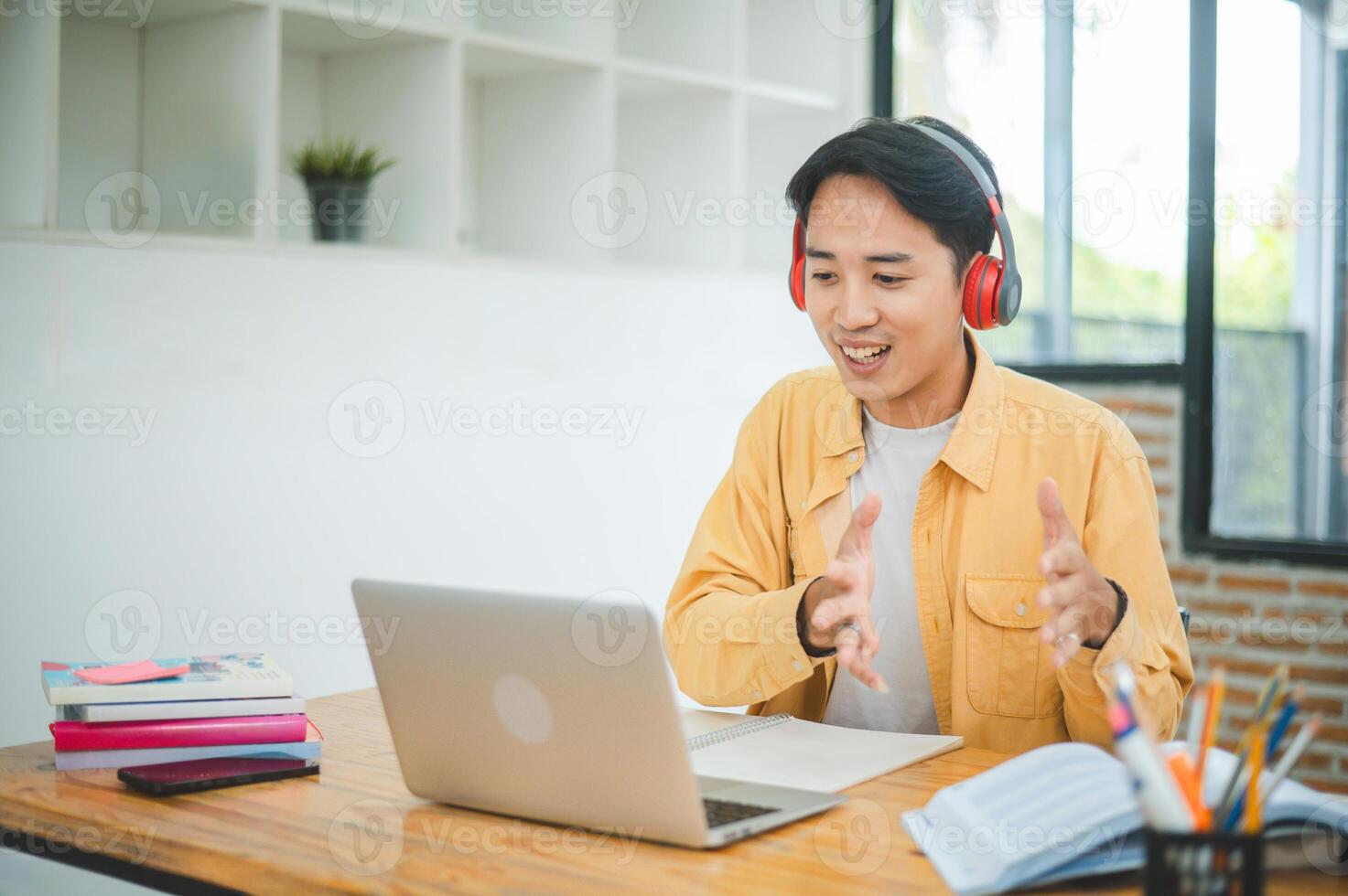 Teenage Asian students wearing a headphone are communicating through conferencing for online learning. In a conference call via apps. photo