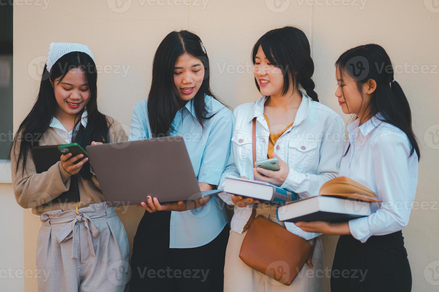 group of students young university students consulting doing homework, cooperating research plan Discuss concepts and strategies. Prepare presentations on laptops and tablet computers. photo