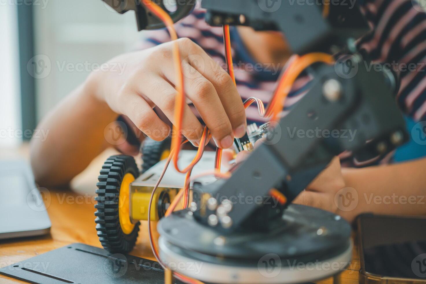 Asian boy learning and studying the work of technology robots.homeschool and science for tech project. playing childhood kids hobby leisure lifestyle people toys robotics technology. photo