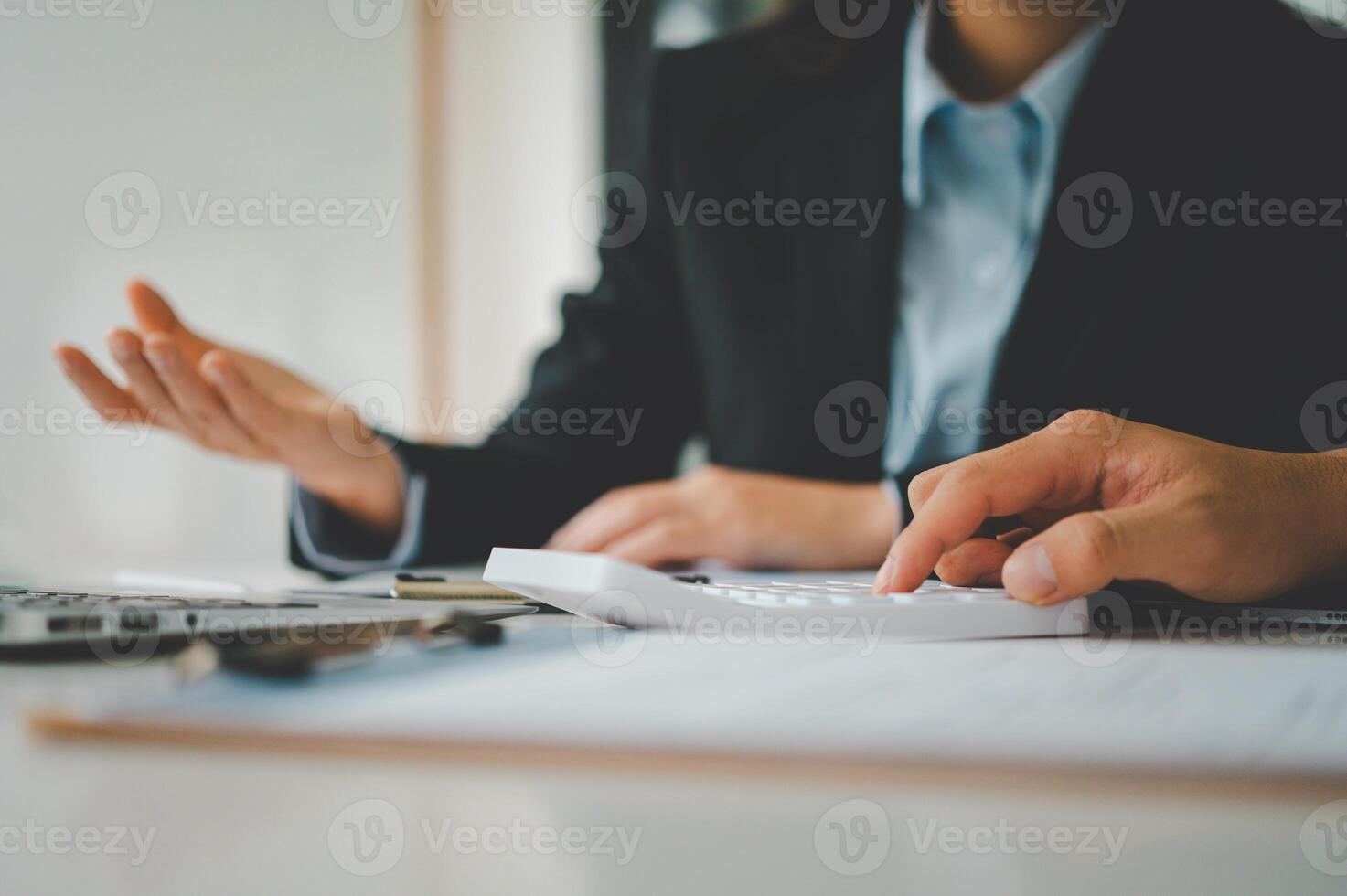 close up The business person is sitting on a calculator with a graph in the office of finance accounting concept photo