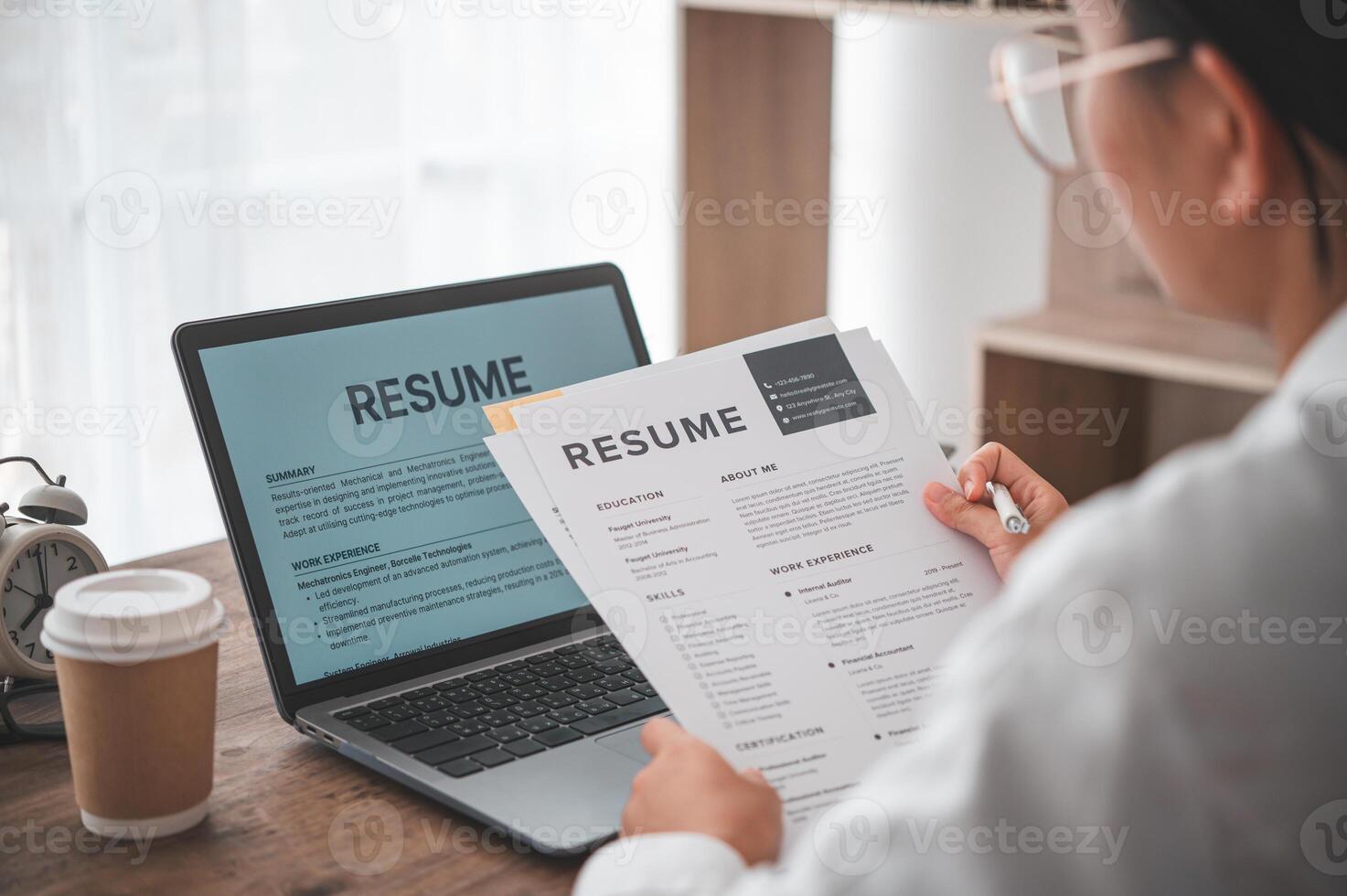People are reviewing job applications before filling out their resume on the job application form in order to apply for a job at a company. photo
