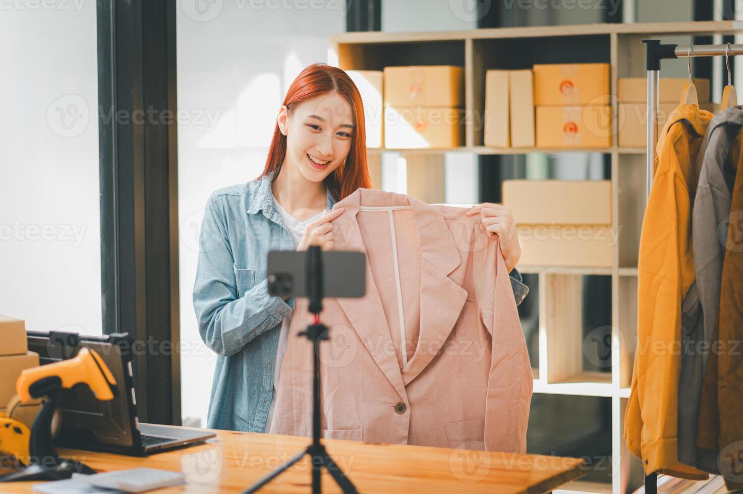 SME owner using the smartphone and tablet for recording . vlog and live stream at her shop,SME business concept, online shopping. photo
