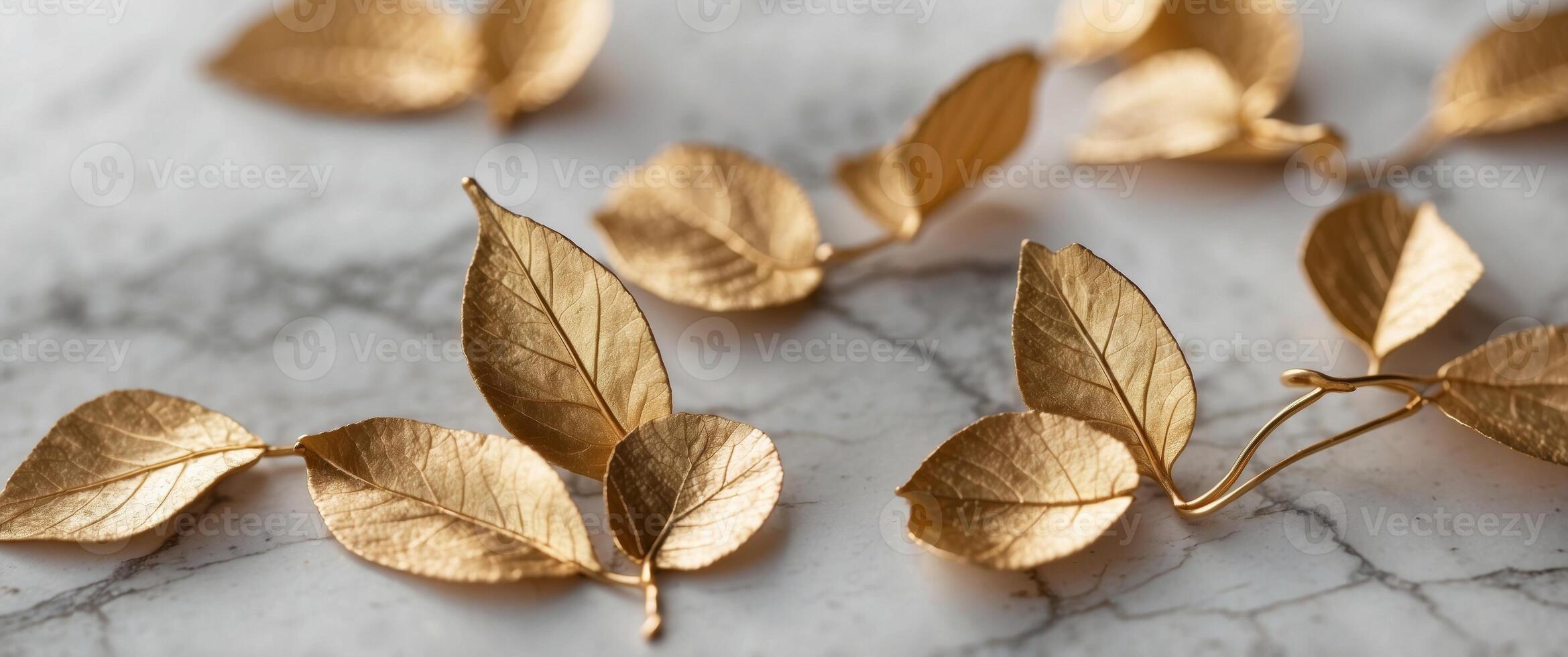 A white marble background with gold leaves on it. photo