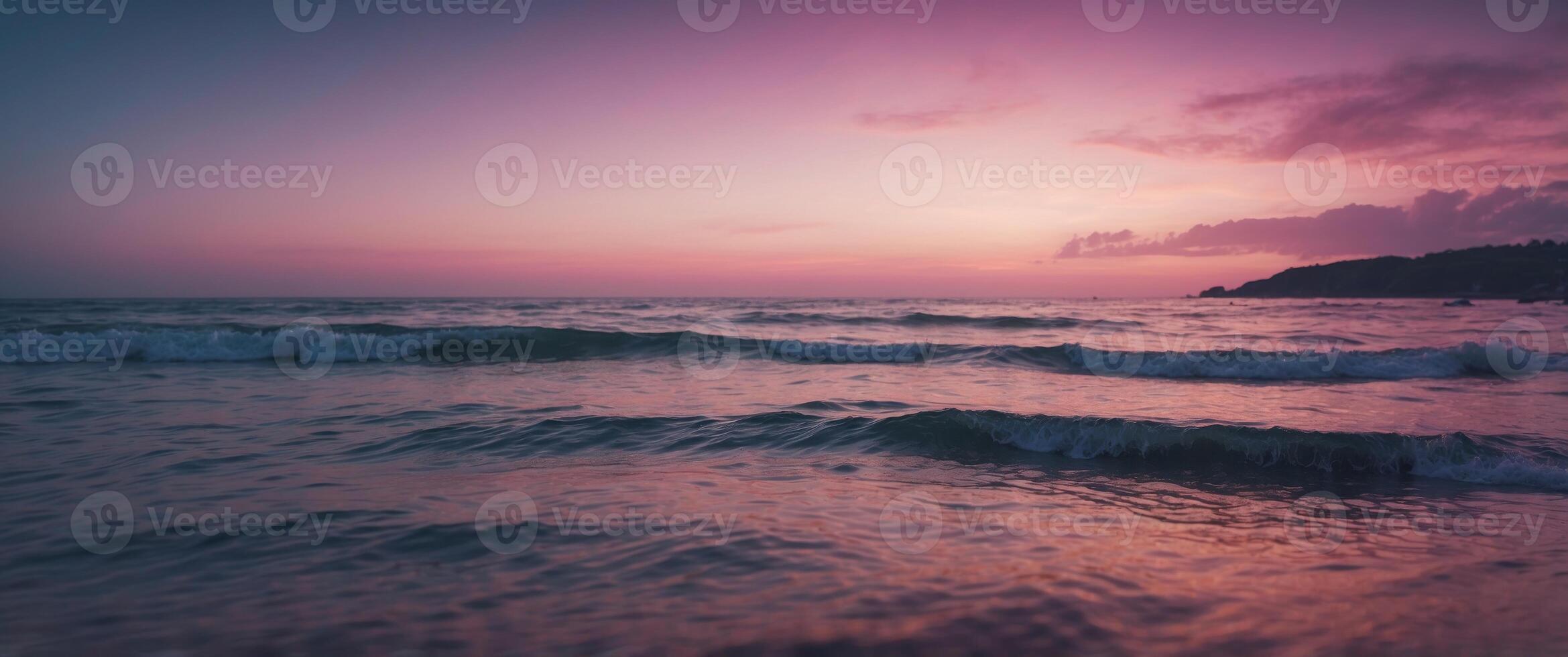 A beautiful pink and blue ocean scene with a purple sky. photo