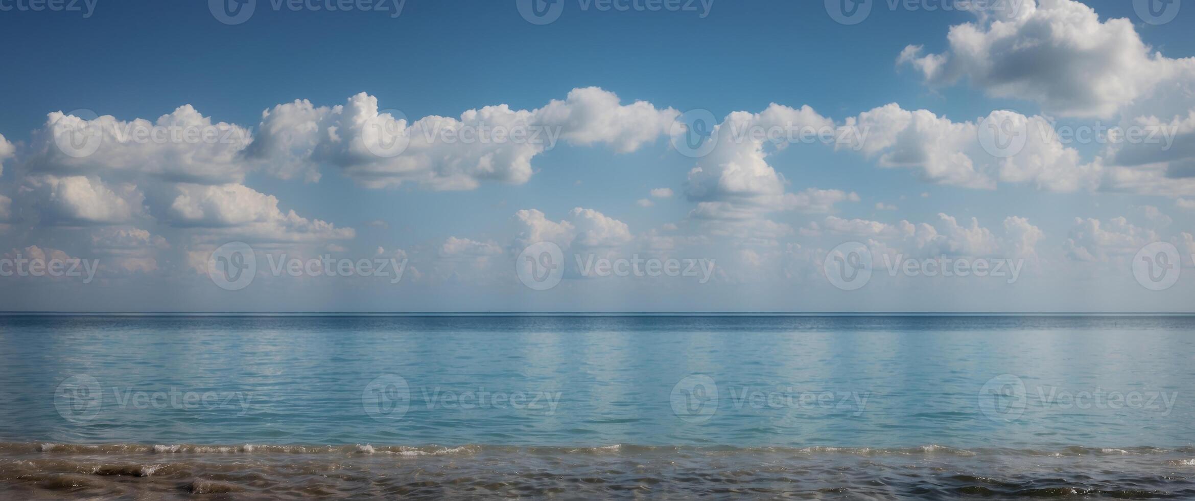 A beautiful blue ocean with a few clouds in the sky. photo