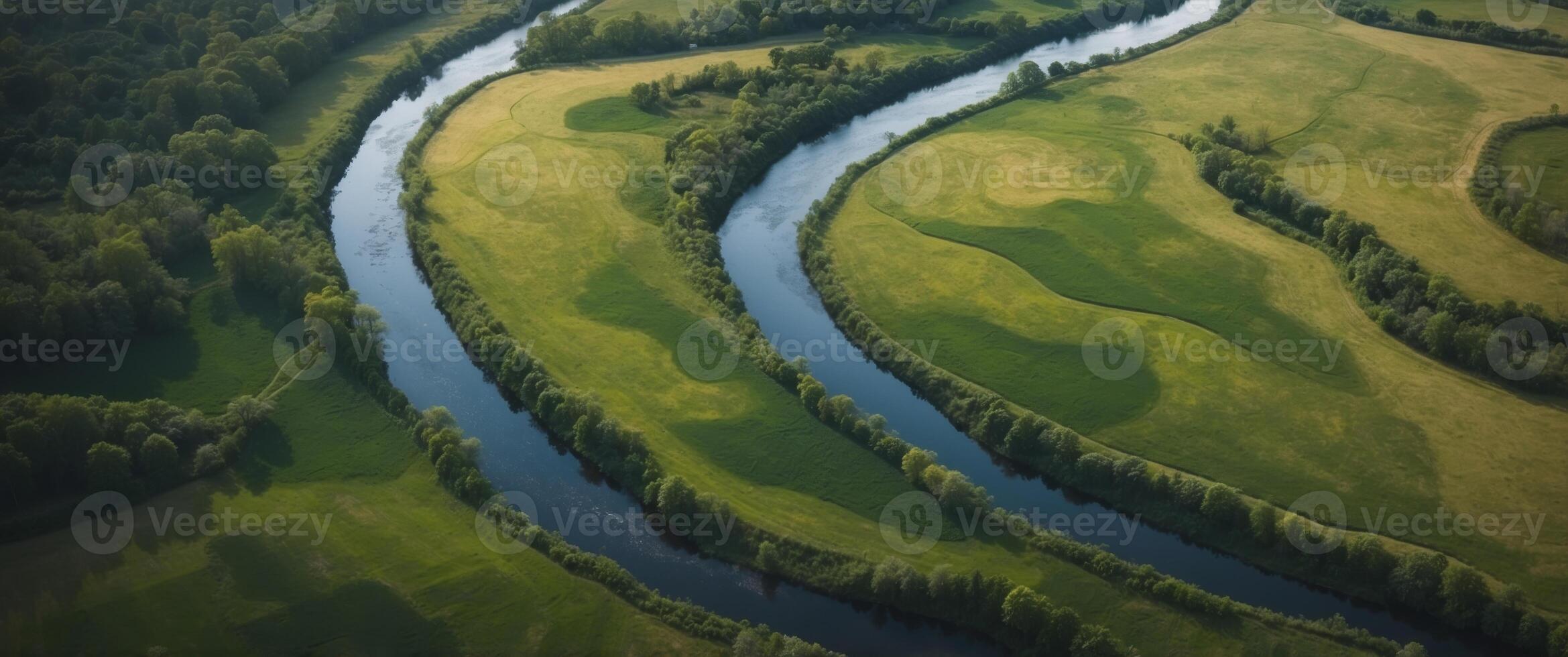 Aerial View of a Winding River Through Lush Green Fields and Forests. photo