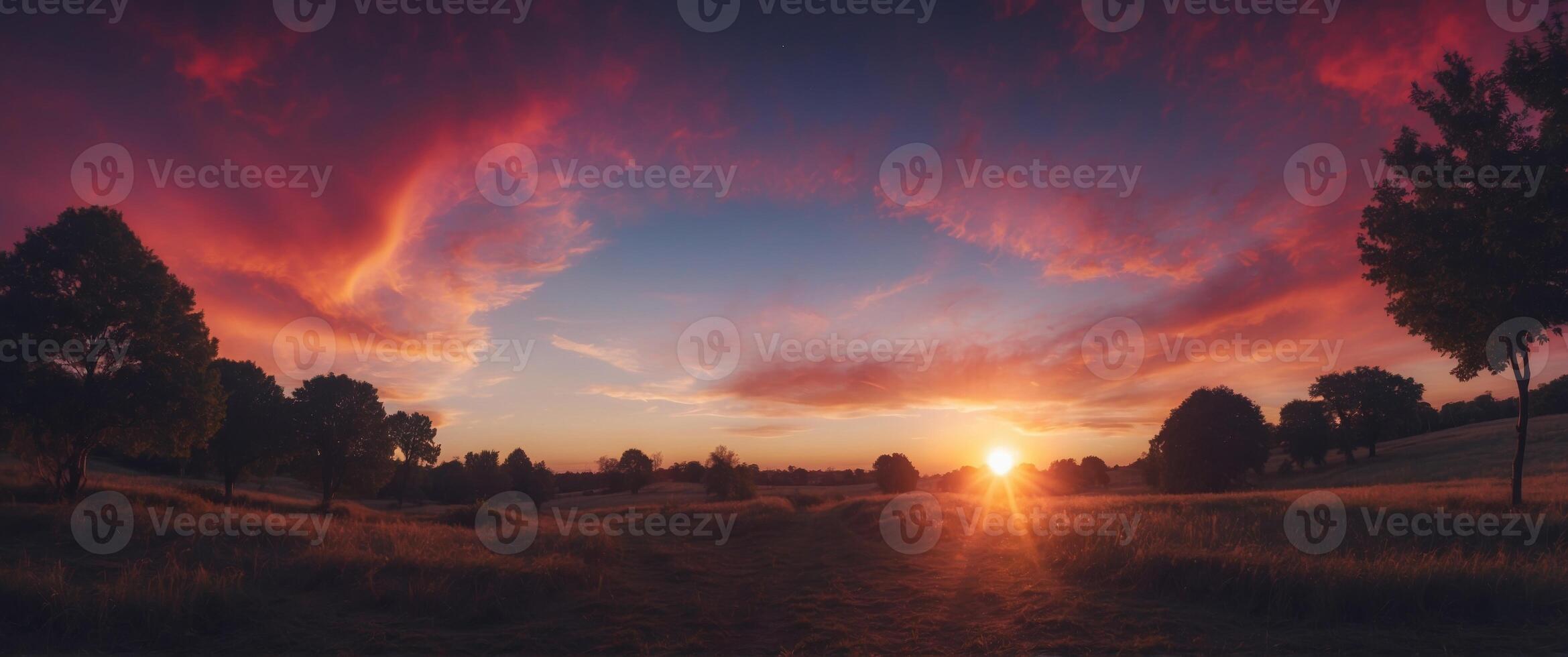 A bright blue and purple sky with a bright red sun. photo