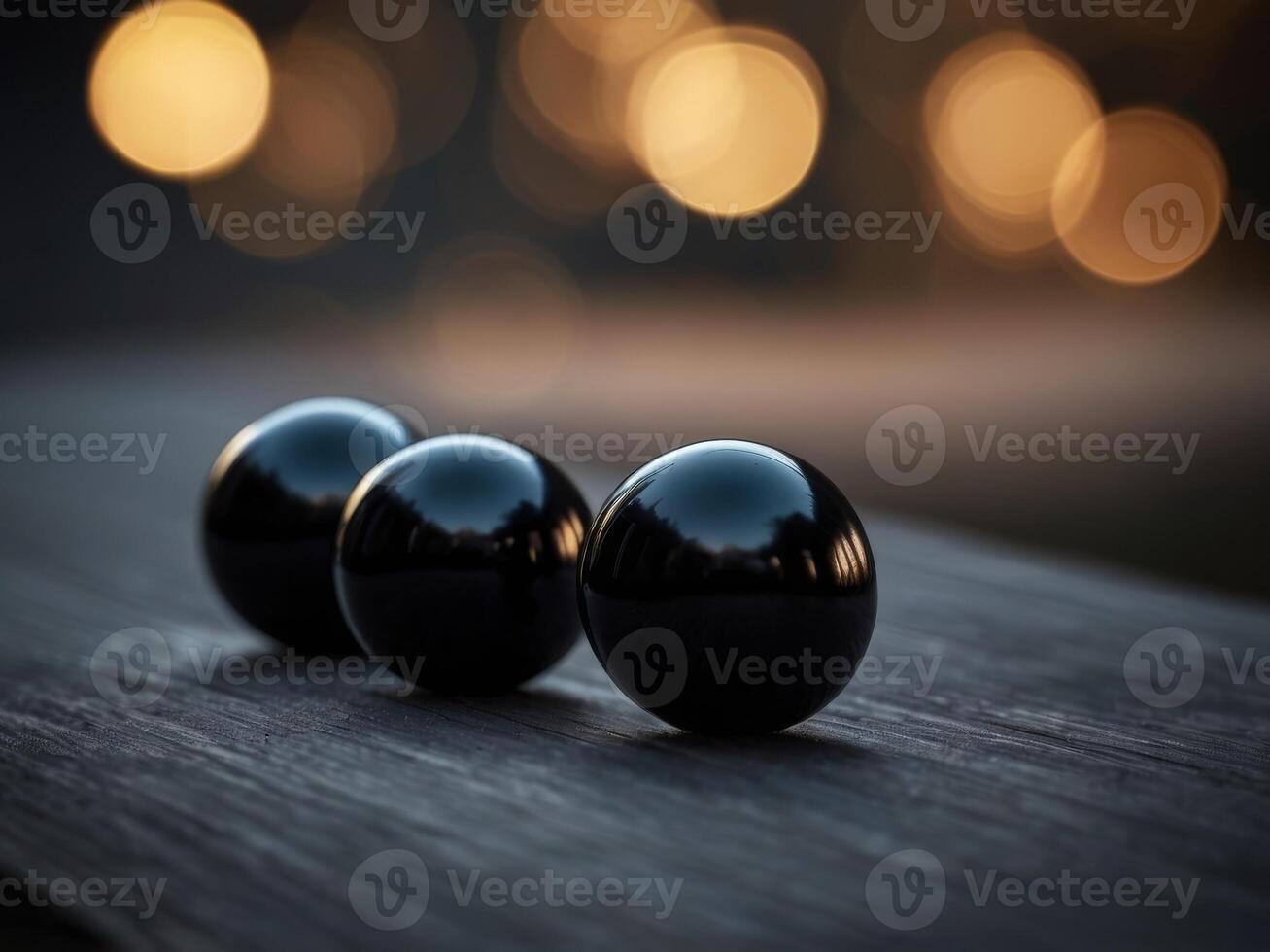 A black background with three black round objects on it. photo