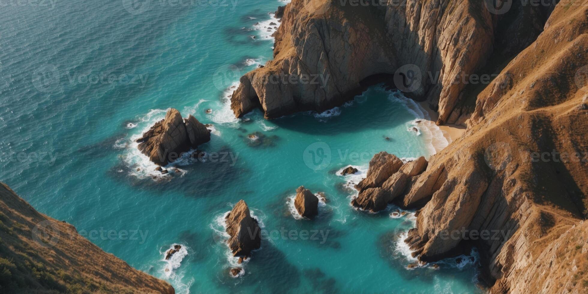 Drone perspective of craggy coastal cliffs and turquoise sea. photo