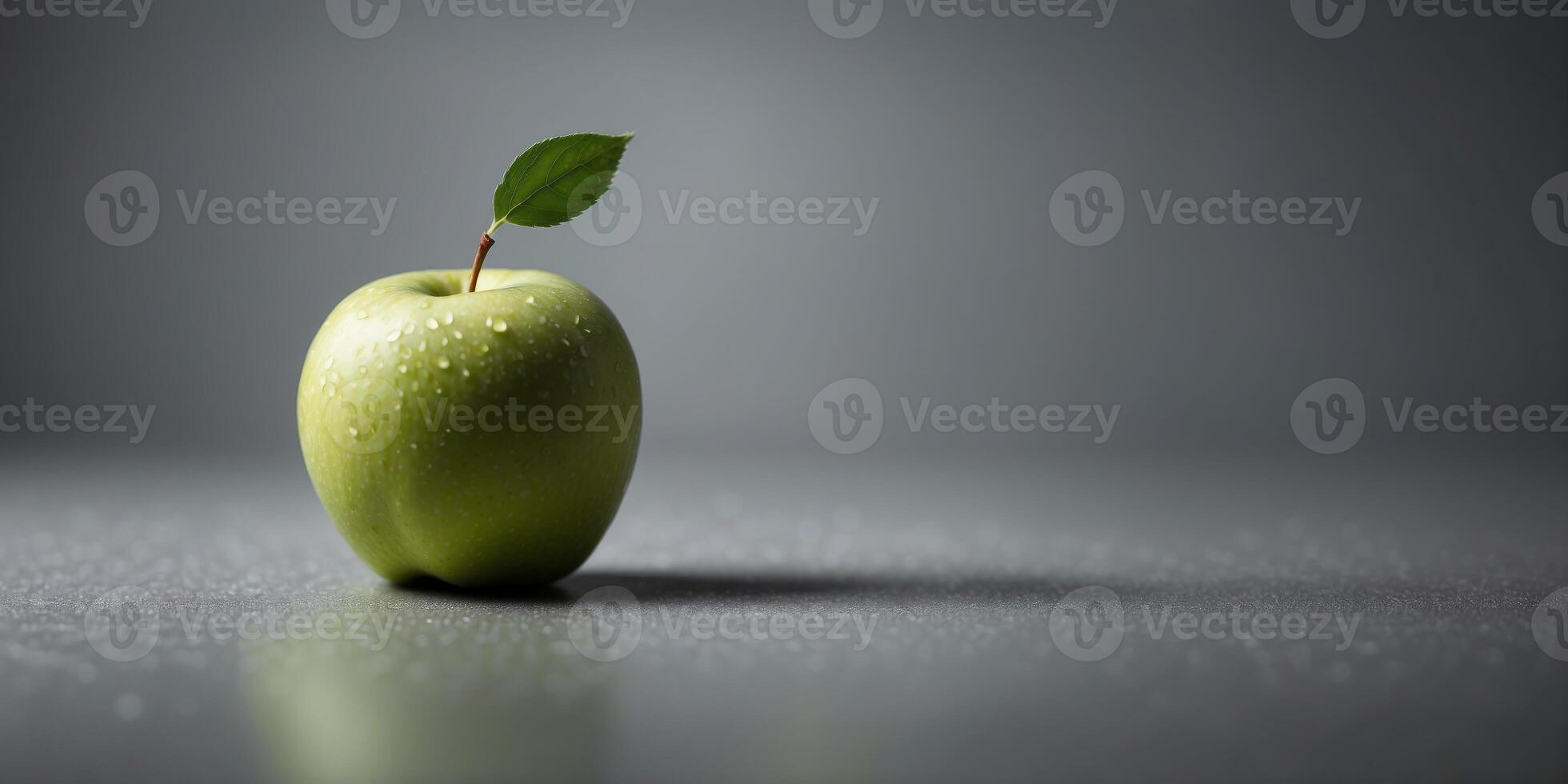 closeup of a single green fresh apple on a grey background. photo