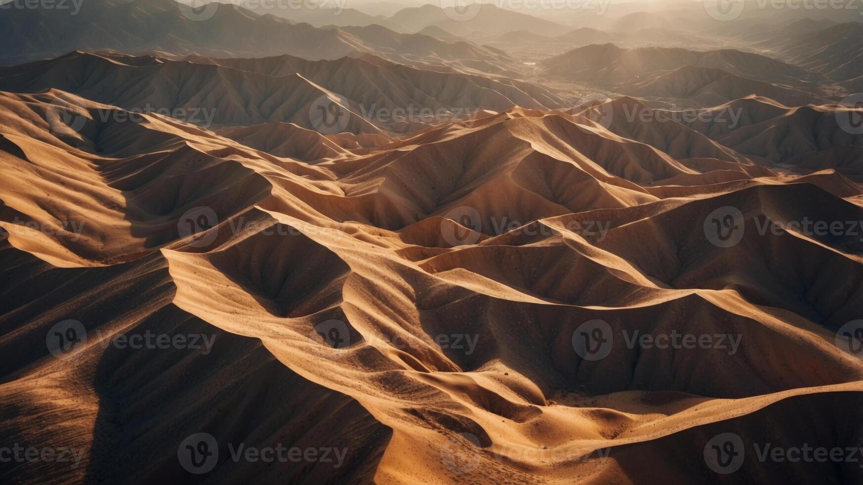 Aerial View of a Rugged Desert Landscape with Dramatic Ridges and Shadows. photo