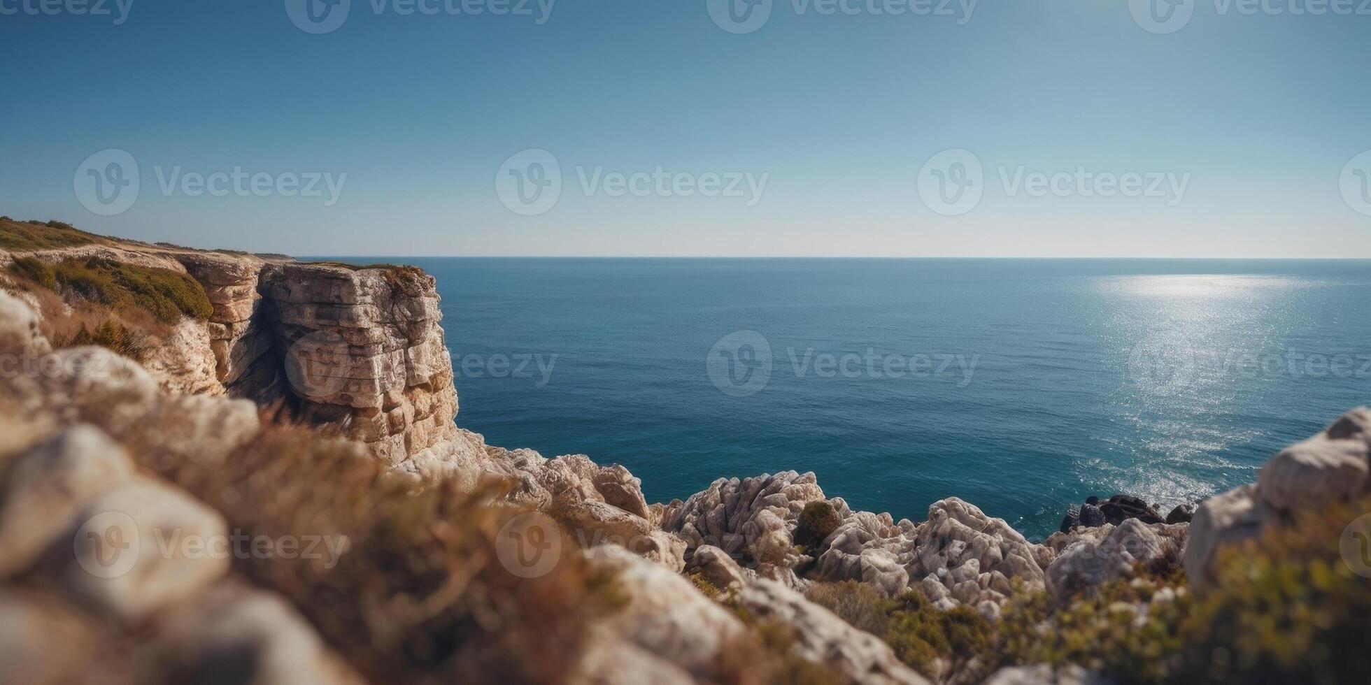 A breathtaking and relaxing view of a coastal cliff with the blue sea and the clear sky. photo