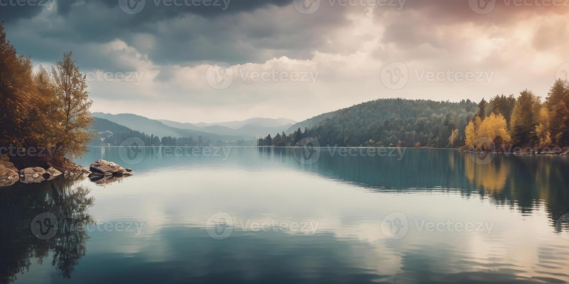 A serene lake scene with a cloudy sky and calm waters. photo