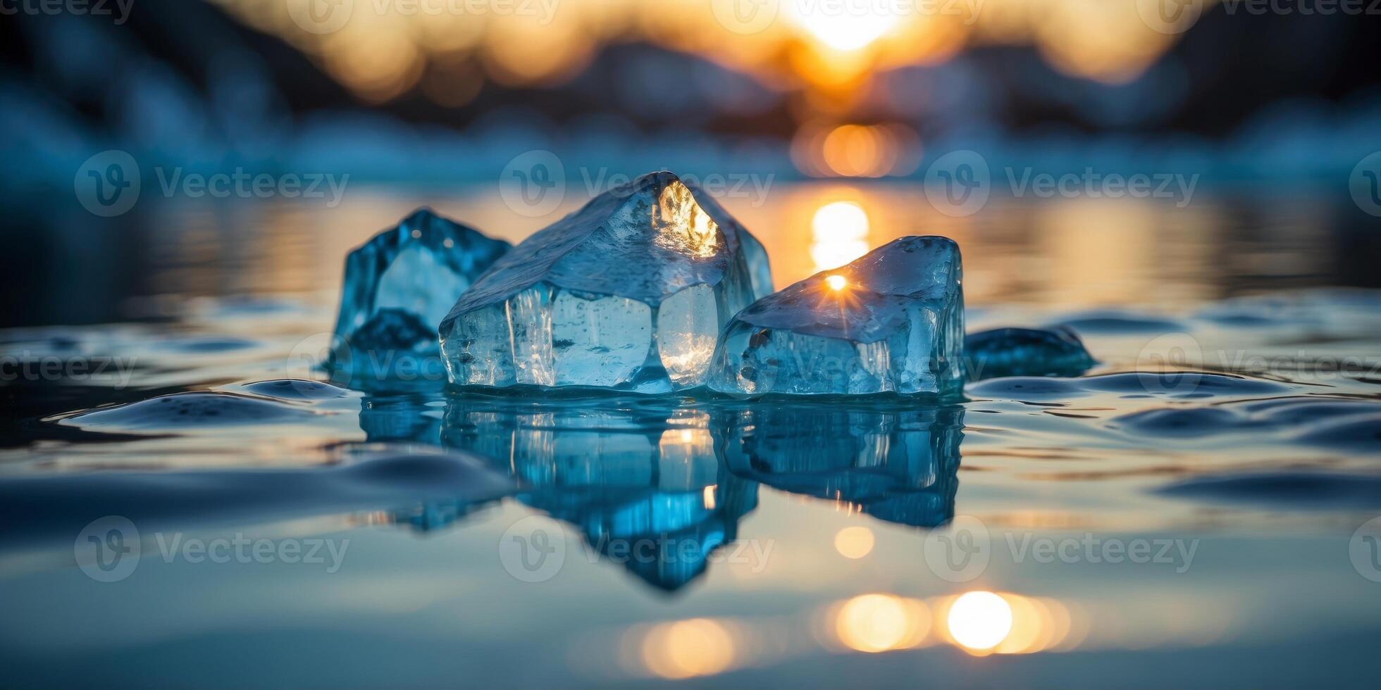Clear blue water reflects the sun as an iceberg sits ominously below the surface. photo