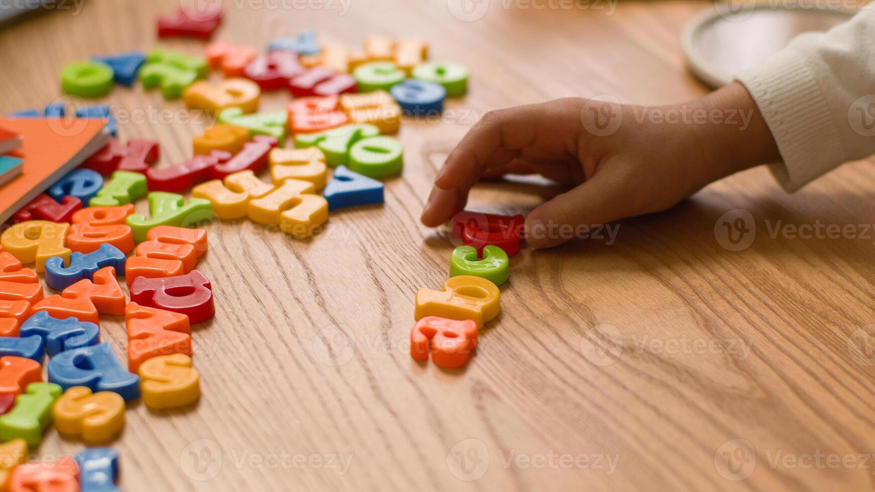 Hands lay out letters alphabet learning study children teach preschool educational kindergarten english language school text lettering development interactive literacy creativity toy colourful toddler photo