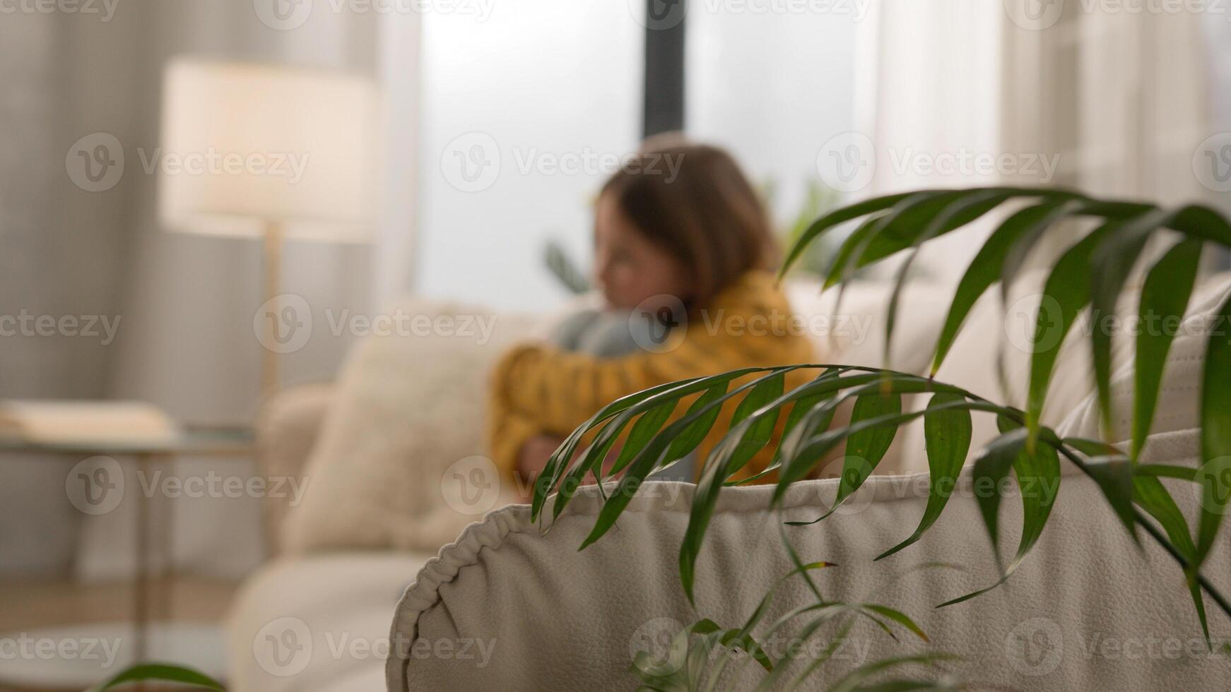 Bored disappointed little Caucasian girl schoolgirl daughter kid hug knees alone home thinking domestic violence school bullying feeling lonely depressed sad upset offended child suffering from abuse photo