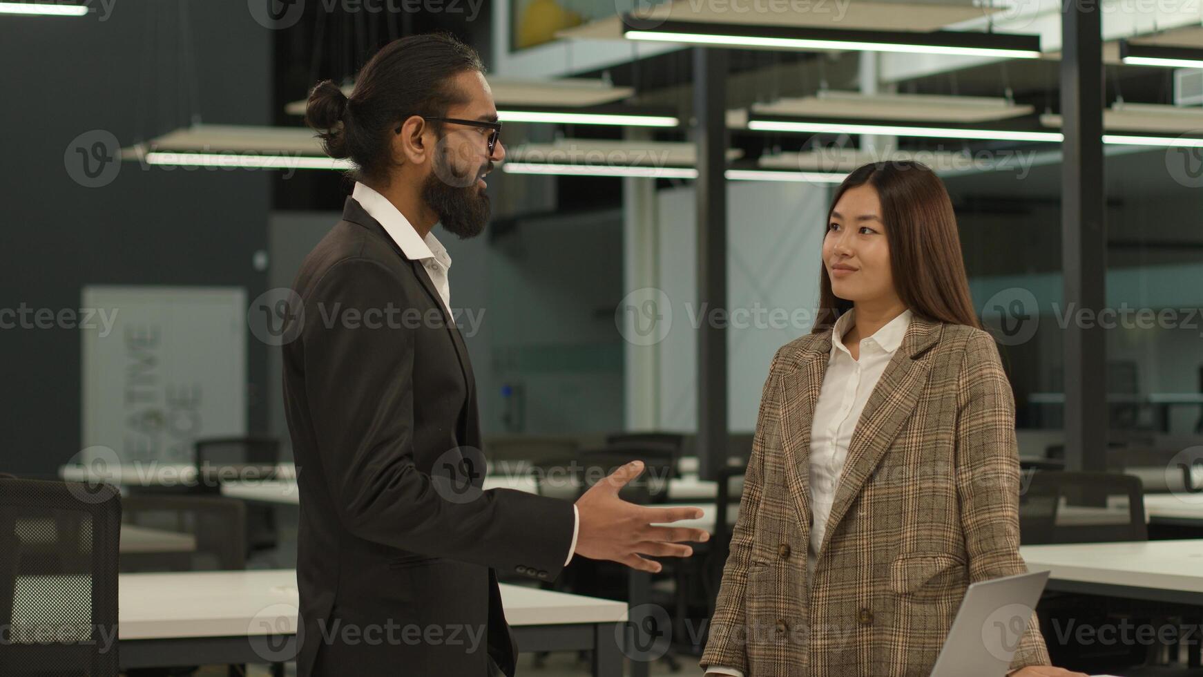 Asian woman Korean worker female girl businesswoman intern at office talking with Muslim Arabian Indian business man guy male leader boss businessman partnership multiracial colleagues talk corporate photo