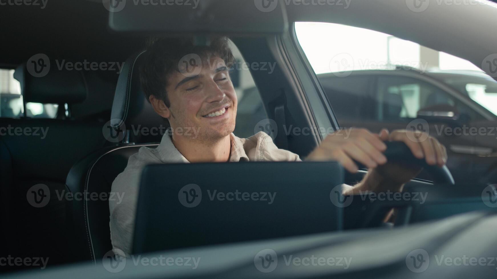Carefree Caucasian driver man sit inside car turning on radio dancing enjoy sound music song dancing clap with hands on steering wheel drive rent auto road traffic modern computer device automobile photo