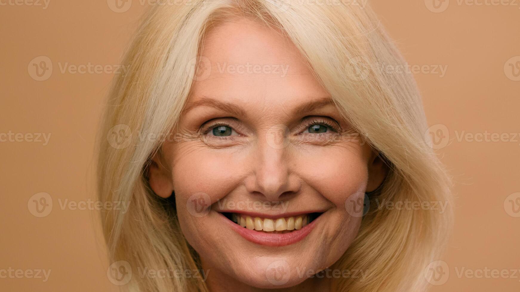 Headshot mature Caucasian 50s woman middle-aged female beautiful model looking at camera anti wrinkle age cosmetic natural makeup beauty skincare face lifting healthy toothy smile on beige background photo
