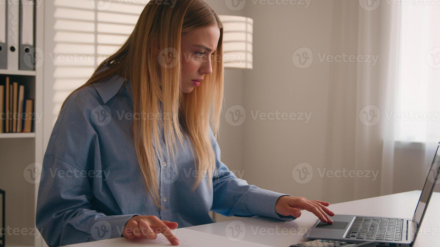 Exhausted frustrated Caucasian girl woman at office table failure angry stressed with paper bills stress about bank loan payments businesswoman counting unpaid taxes with calculator financial problems photo