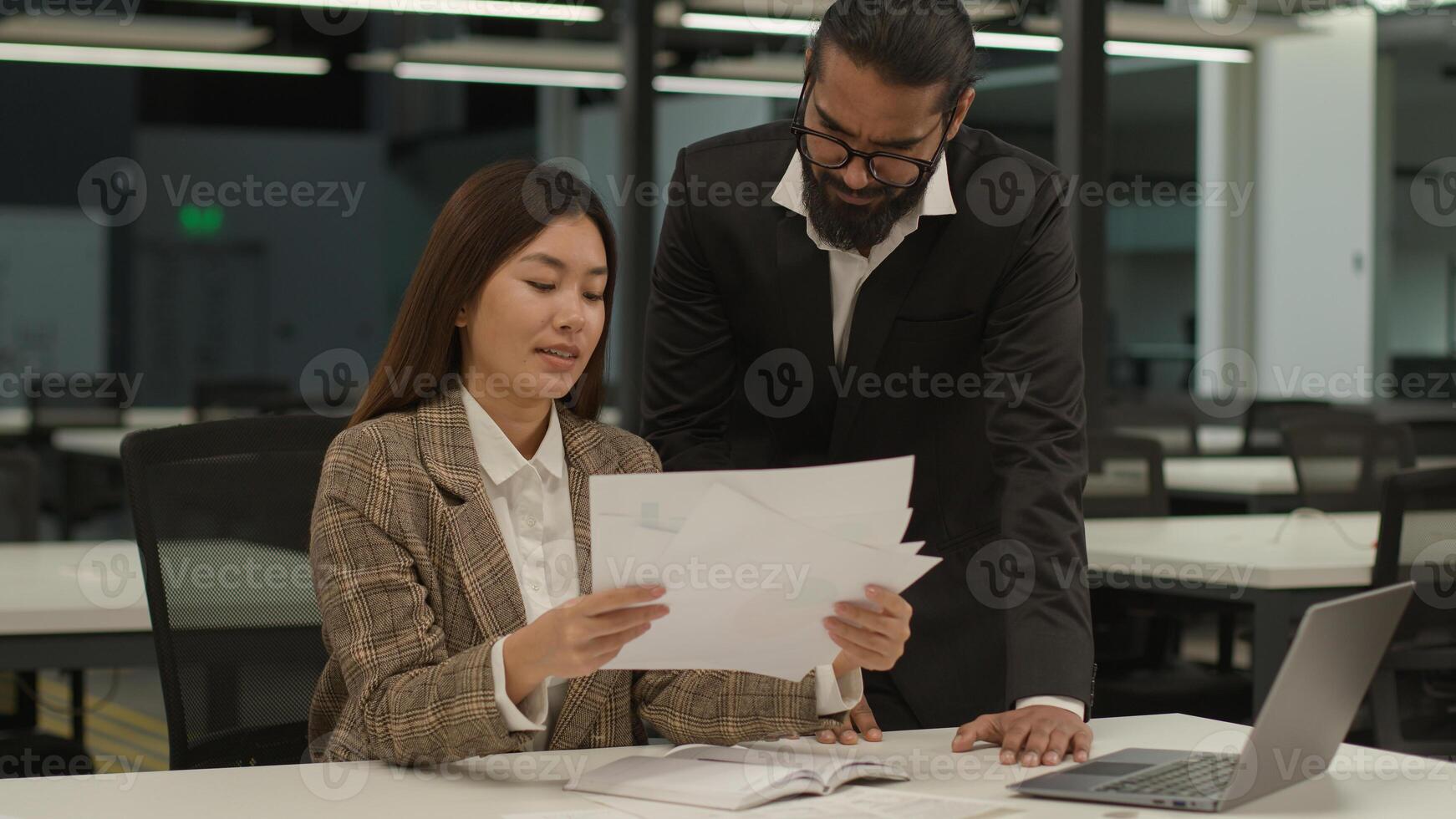 Divers business partners company workers multiethnic colleagues Indian man leader Arabian businessman talk Asian woman employer help Korean businesswoman discuss papers documents paperwork in office photo