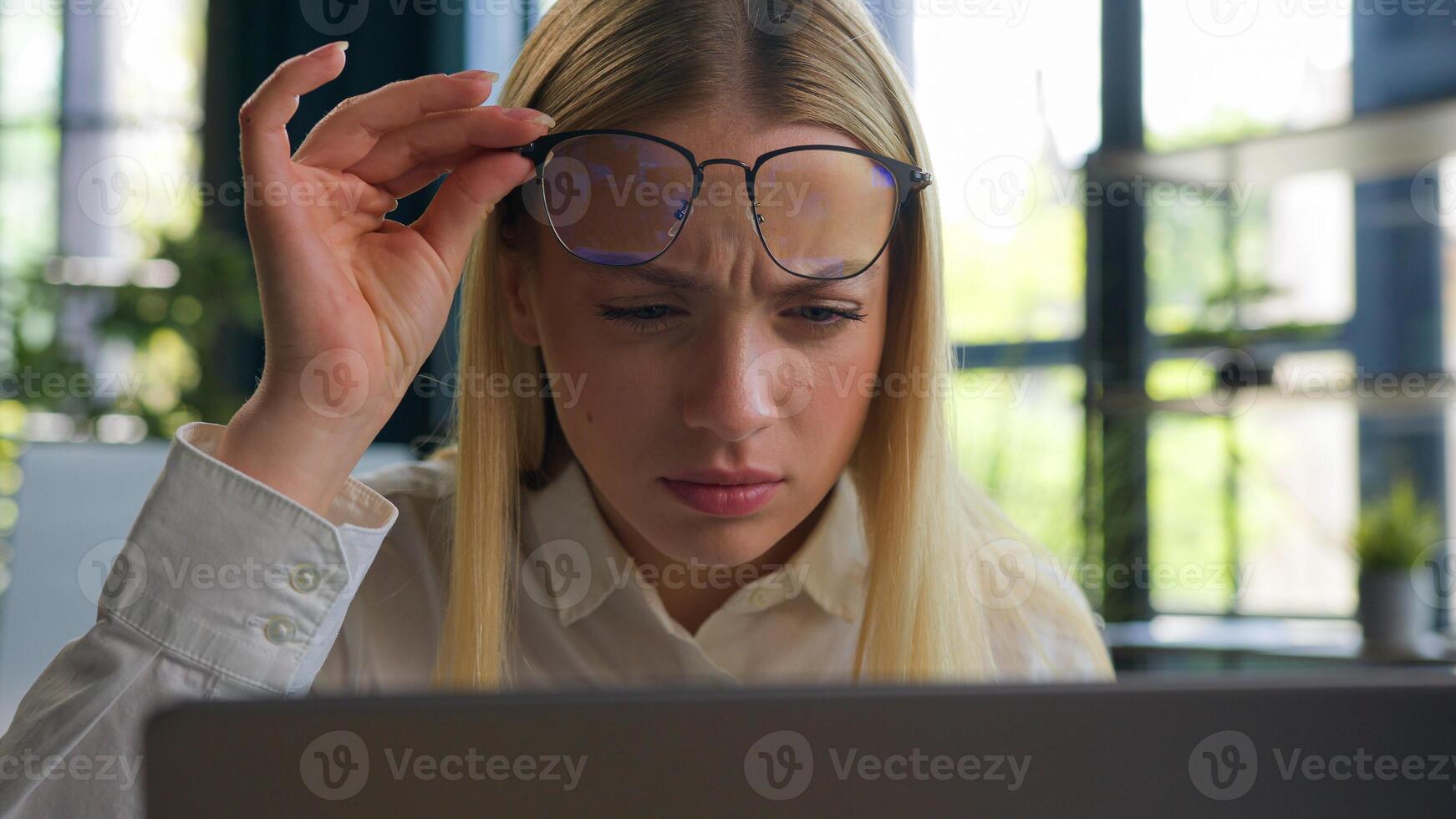 Caucasian woman businesswoman business girl take off glasses looking at laptop screen confused blurry vision after computer overwork in office eyesight problem check bad sight in eyeglasses eyestrain photo