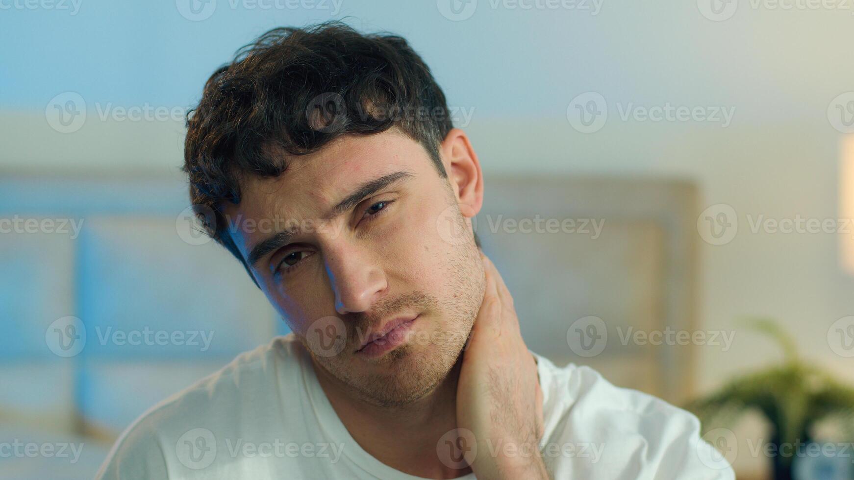 Close up young Caucasian European tired man bored fatigue burnout yawn unhappy boredom exhausted sleepy overwork face lazy portrait melancholy pensive stressed home bedroom inside frustrated morning photo