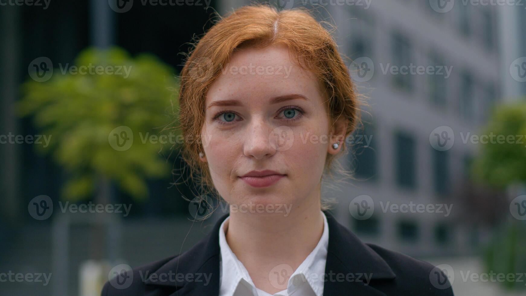 Portrait rich successful confident young Caucasian ginger businesswoman girl female woman formal suit looking serious at camera posing outside town office building business education future profession photo