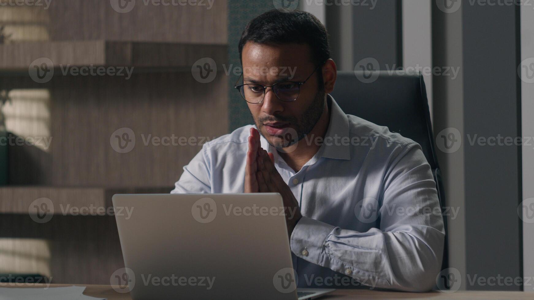 Indian man businessman American investor broker rub hands hoping wish to win lose with laptop at office feel annoyed having problems with computer angry bad result failure data loss password wrong photo