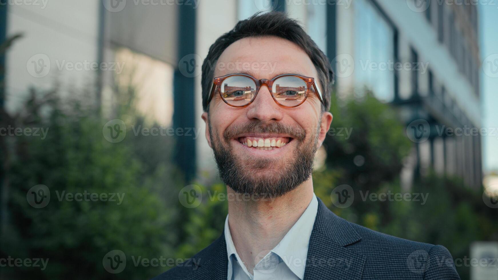 Outdoors happy male portrait Caucasian adult smiling businessman in glasses employer entrepreneur CEO joyful successful leader business man turn head at camera in city near office outside toothy smile photo