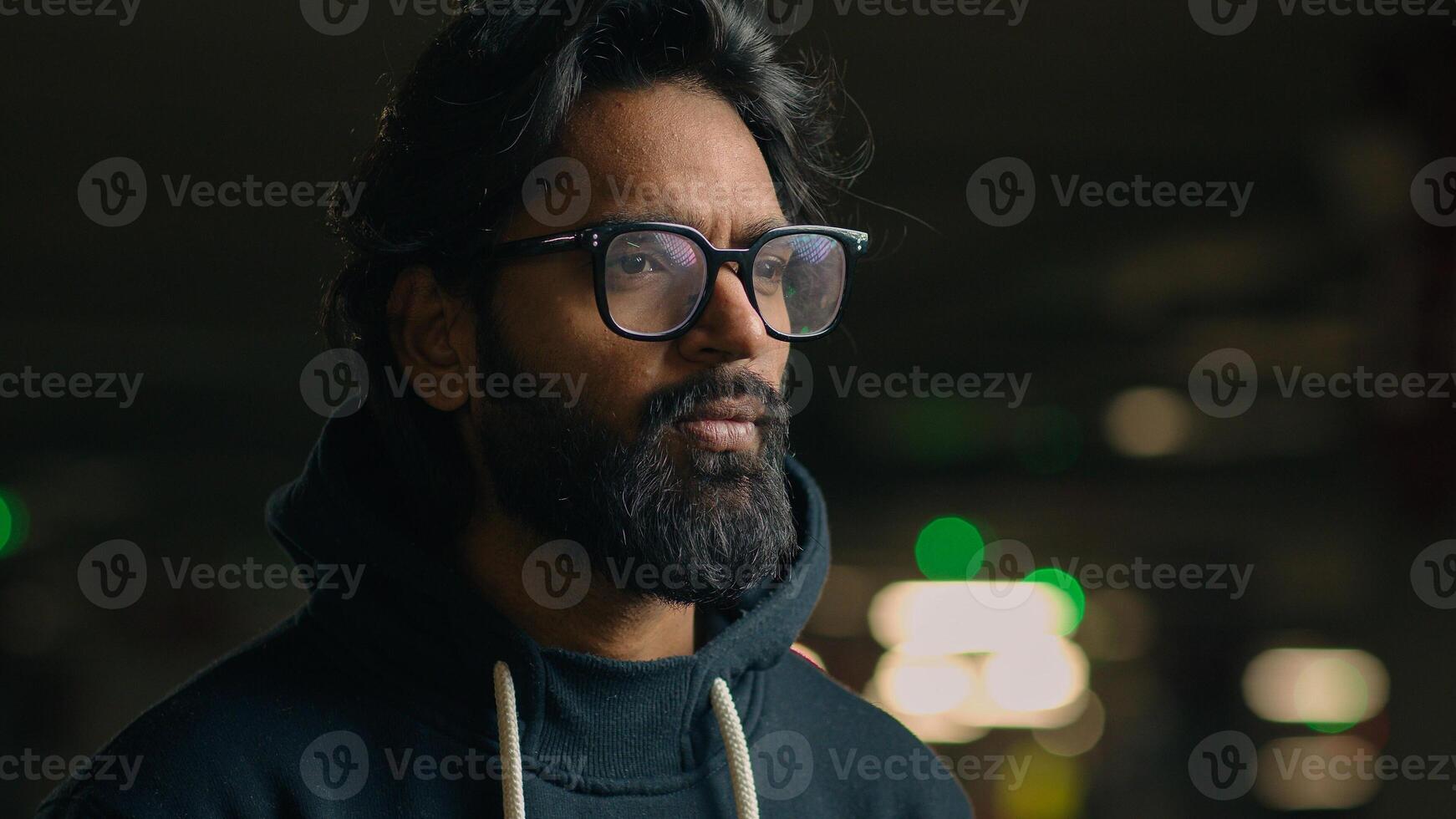 Pensive thoughtful Arabian thinking man ethnic male puzzled pondering think guy at dark parking lot looking away ponder decision solution serious waiting hesitate unsure wait problem solving alone photo