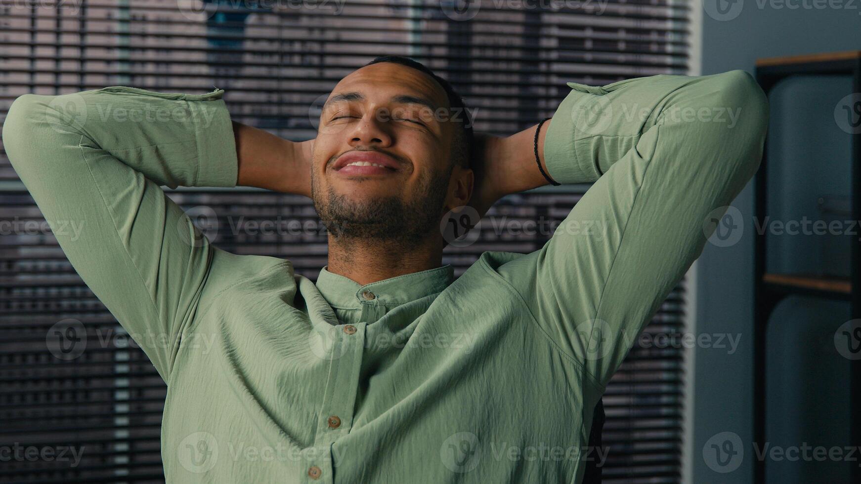 Relaxed satisfied businessman office manager employee resting dreaming at workplace taking break happy african american man holding hands behind head finished work relax with closed eyes after project photo