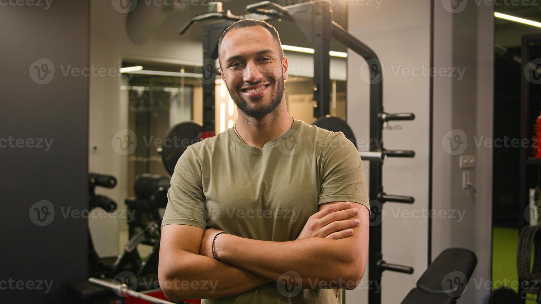 Moving zoom camera strong African American man fitness trainer invite to gym with come here gesture inviting to sport workout sportsman athlete welcome invitation to join training posing crossed arms photo