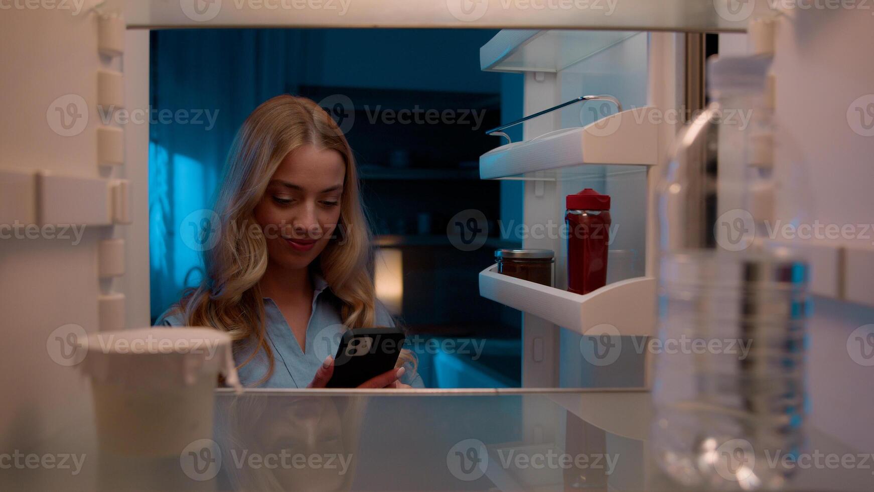 Point of view POV inside refrigerator Caucasian girl hungry woman open fridge at home kitchen look at empty shelves order food products delivery with mobile phone app online service web store shopping photo