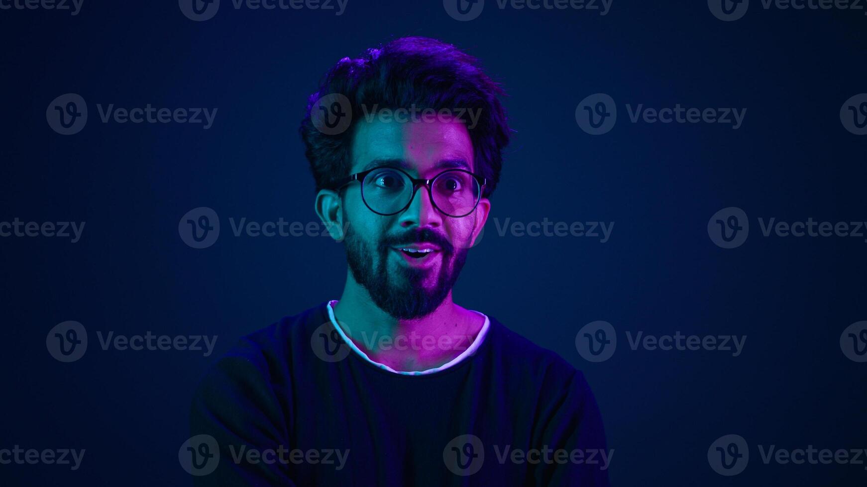 Shocked amazed astonish wonder excited Indian man coder hacker computer futuristic high-tech technology software user hacker looking shock wow in neon background hologram mock up infographic backdrop photo