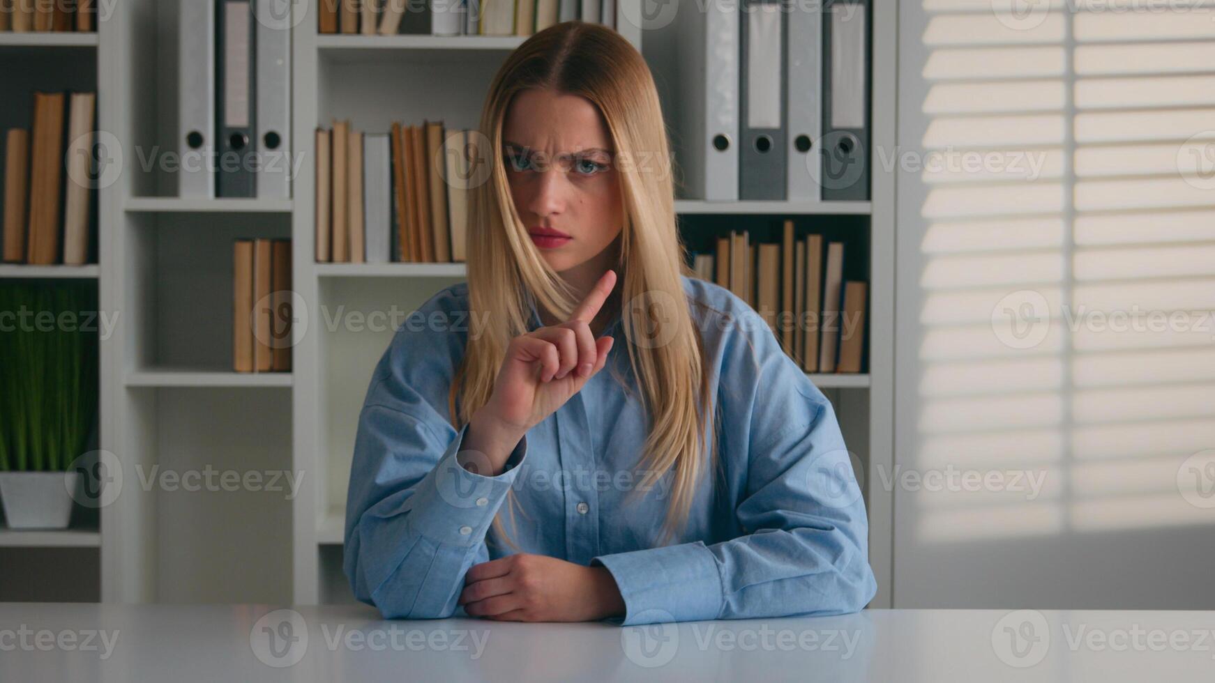 Caucasian dissatisfied negative disappointed frowning student girl in library woman waving head no index finger answer deny rejection never not reject gesture Businesswoman at office forbid refusal photo