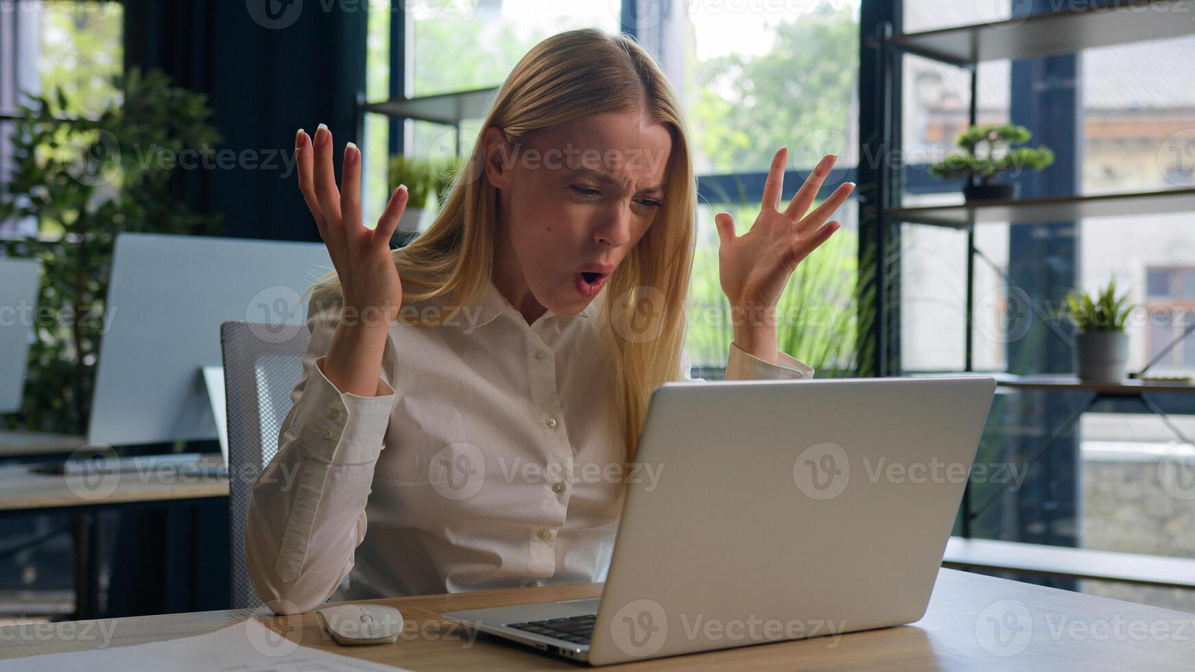 Upset shocked businesswoman Caucasian woman manager working laptop lost business failure problem negative shock computer trouble bankruptcy mistake read bad email stressed frustrated girl at office photo