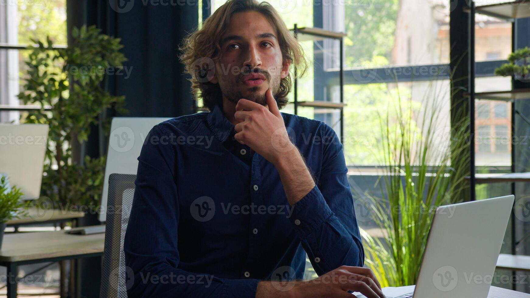 Thoughtful Arabian businessman pensive puzzled office worker male employer business manager CEO doubtful ethnic man working with laptop computer think idea plan creative mind solve problem solution photo