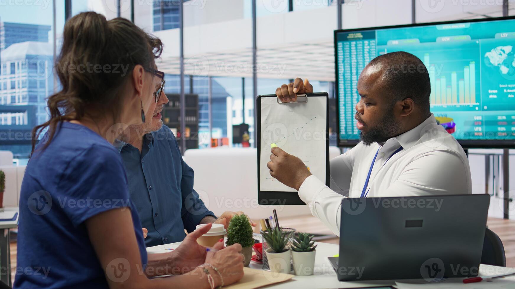 Financial broker exploring retirement plans with old person in modern office, counseling session to ensure life savings and family expenses. Professional advisory meeting for future. Camera B. photo