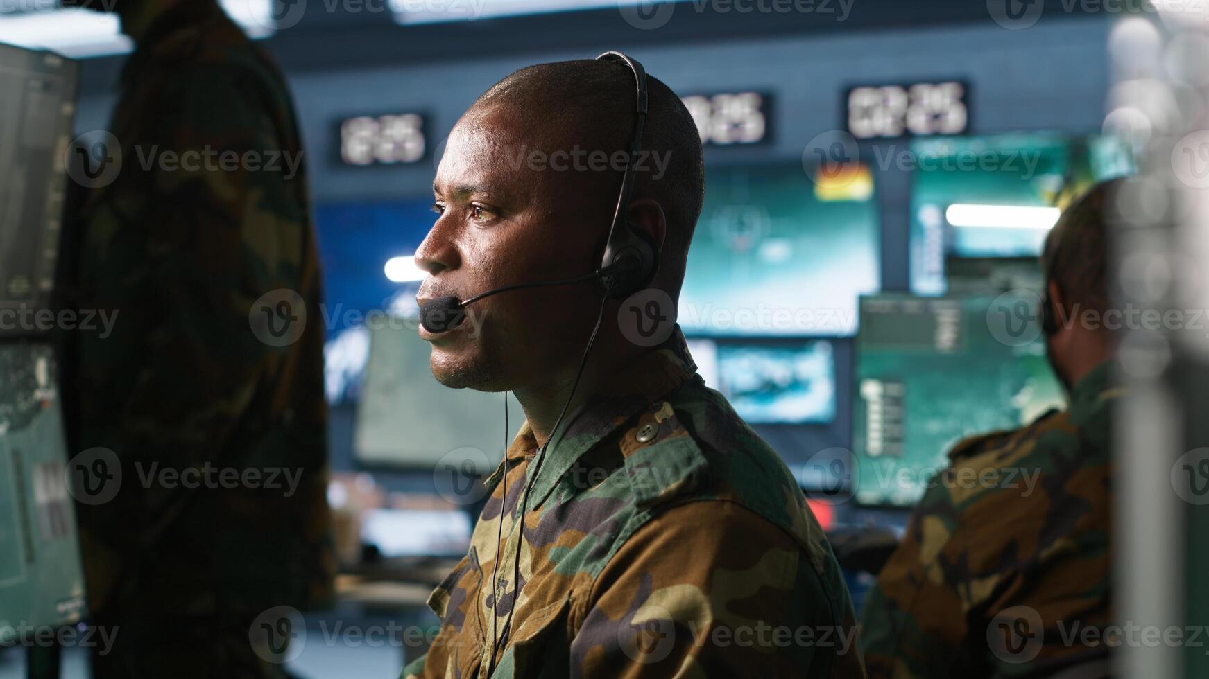 Army telecommunication systems operator using radio gear, providing combat support, doing patriotic duty. African american military dispatcher managing communications networks, camera A photo