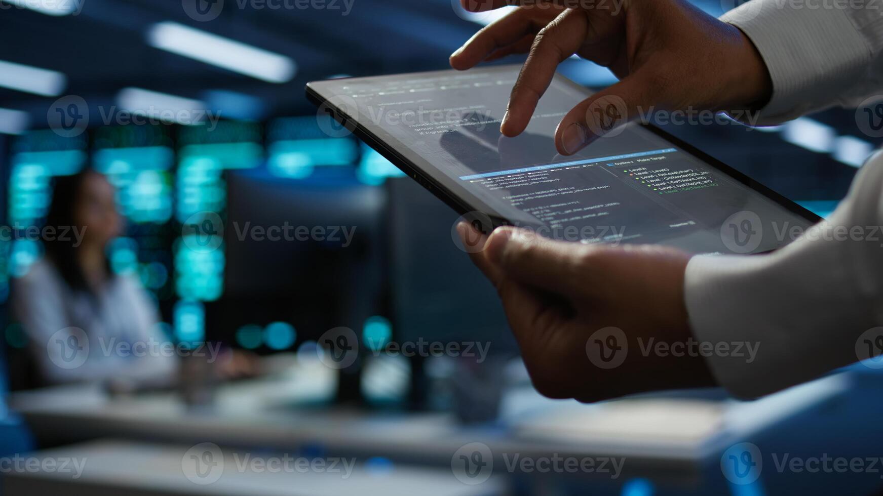 Programmer using device in data center, managing servers, operating systems. Close up of specialist in server hub using tablet to ensure networks are secure and functioning properly, camera B photo