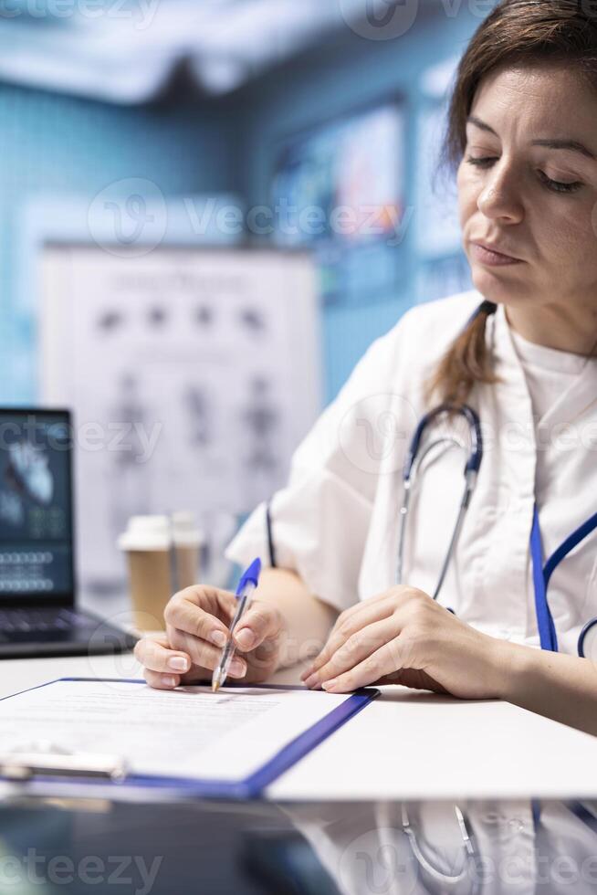 General practitioner giving a prescription with drugs treatment to help patient with disease, recommending medicaments and vitamins with the right dosage. Medic working in healthcare industry. photo