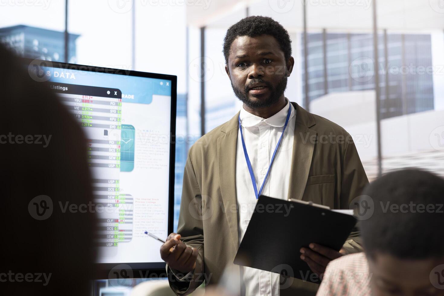 Financial expert briefing his team members about new enterprise objectives, showing analysis of their budget and expenses on interactive board. Resource allocation and project planning meeting. photo