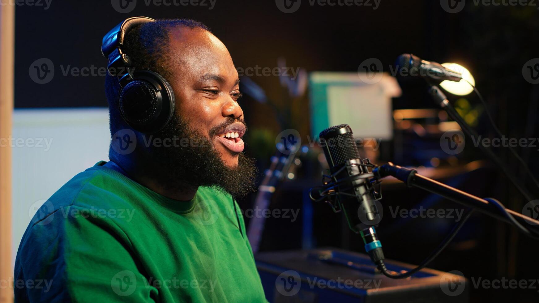 Young songwriter playing piano and singing on microphone, recording his new music and mixing the tunes on digital software. Musician composer producing soundtracks with modern gear. Camera A. photo