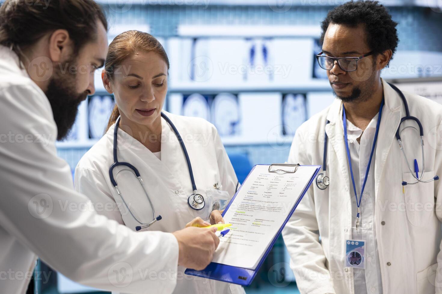 Diverse team of physicians examining hospital records and x ray results, looking at ct scan and radiography to put the right diagnostic. Experts doing teamwork to ensure disease prevention. photo