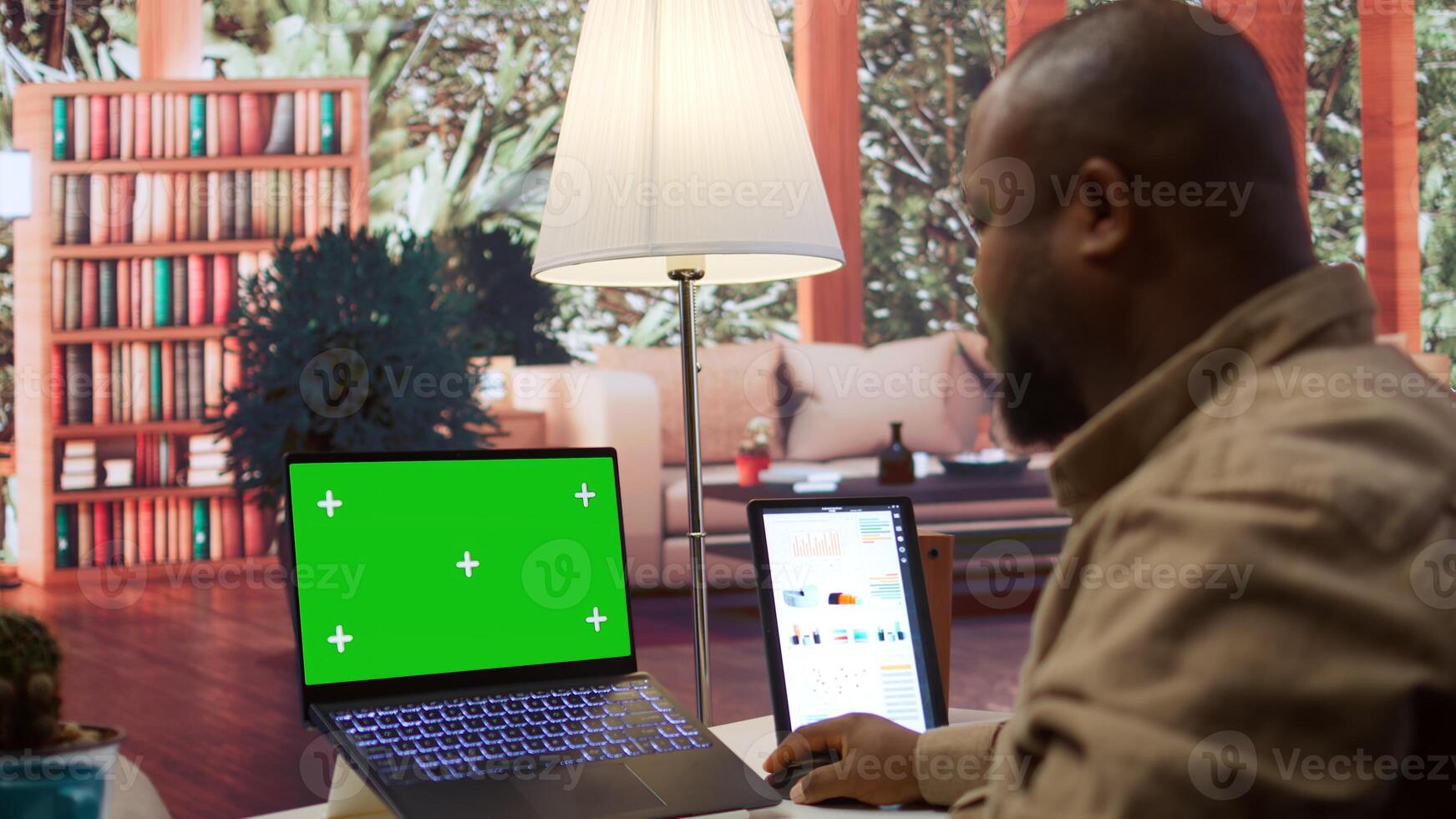 Financial adviser works with infographics next to a copy space mockup display, using accounts balance to create a correct economic report. Entrepreneur examines business data. Camera B. photo